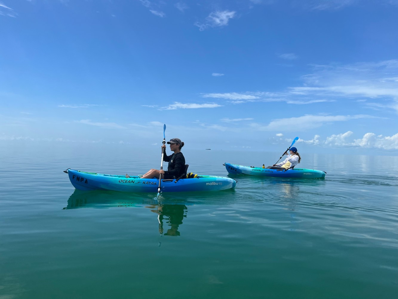 a person riding on the back of a boat in the water